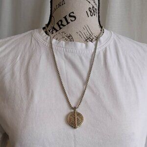 Silver chain and charm case & a coin bearing the image of the Chinese Buddha